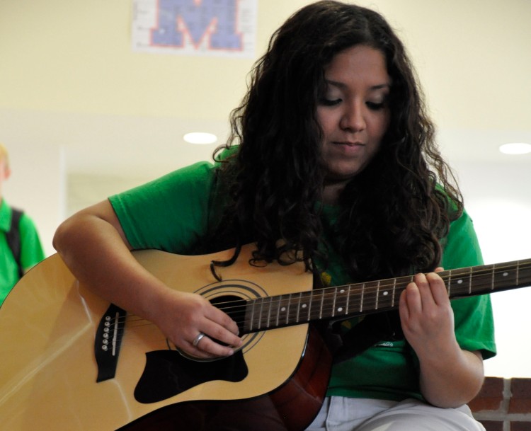 Photo by Brighton Nivers Strumming Away Castaneda sharing one of her songs with the newspaper staff.